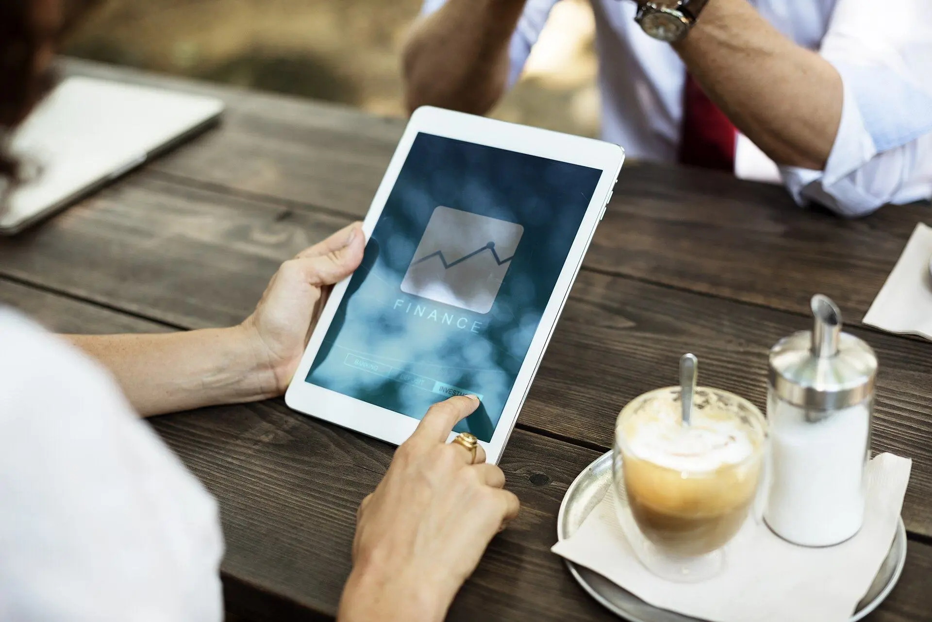 A person checking a finance app on a tablet