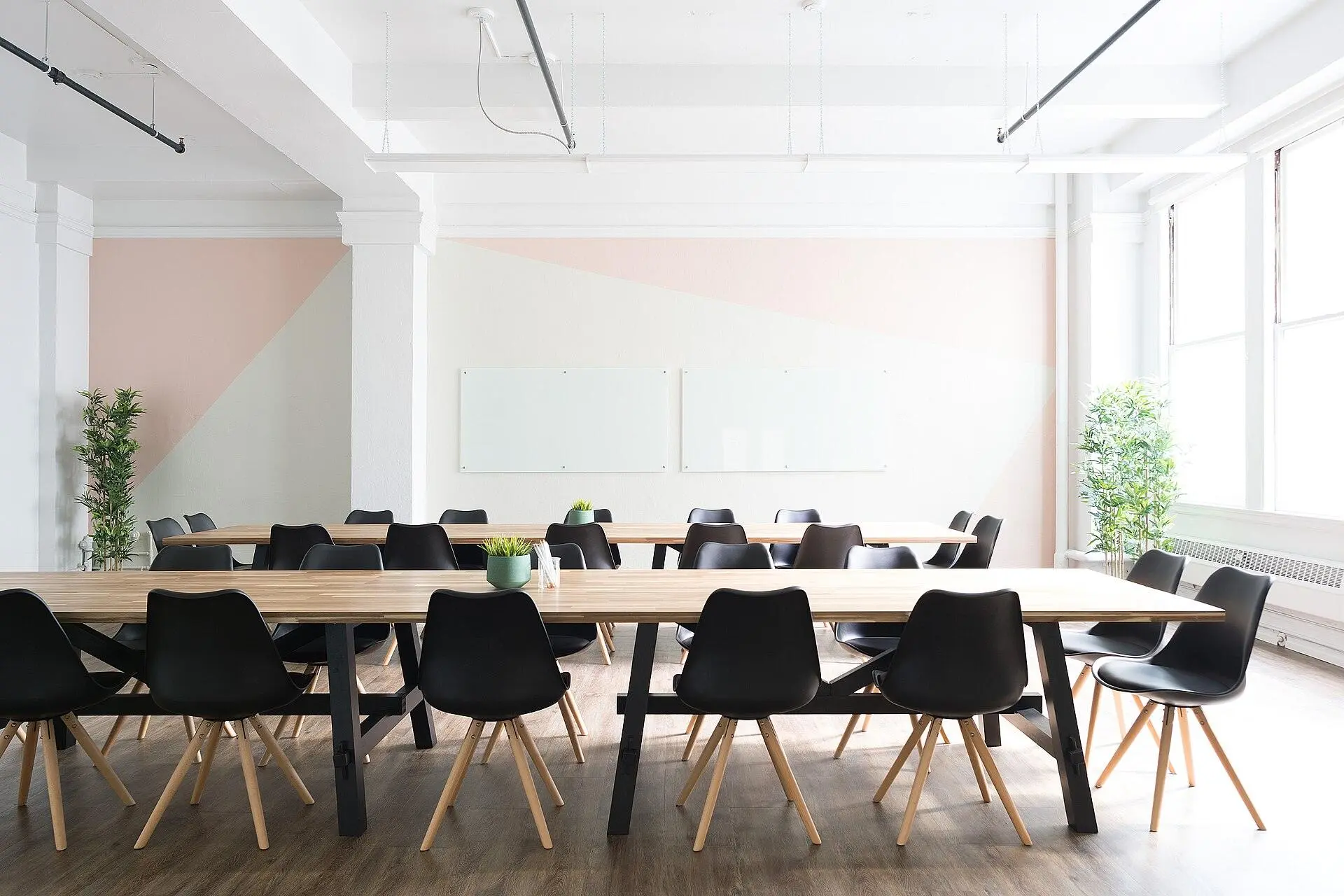 A bright workspace with a long table and chairs